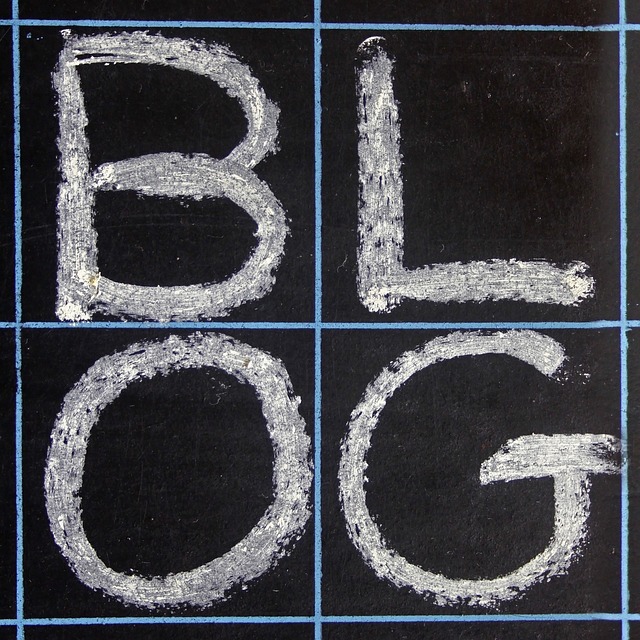 The word "BLOG" written in white chalk on a blackboard, divided into a grid format.